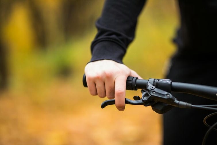 biker-s-hand-handlebars-while-ride-autumn-park-close-up_231208-989